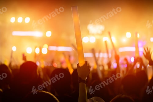 Preview: Crowd of concert stage lights and people fan audience silhouette raising hands or glow stick holding