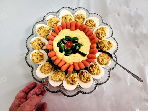 Preview: Overhead food flat lay deviled eggs prepared for party.