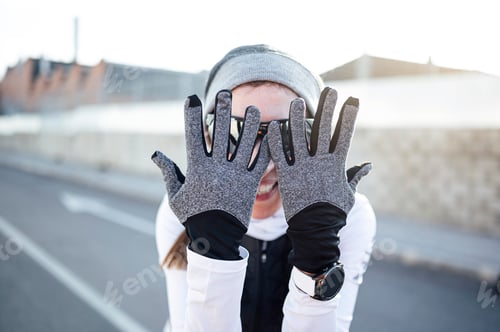 Preview: Happy athlete covering face with hands before starting to run