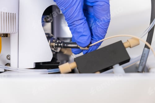 Preview: Chemist connecting nebulizer to ion source of mass spectrometer. Liquid chromatography with mass