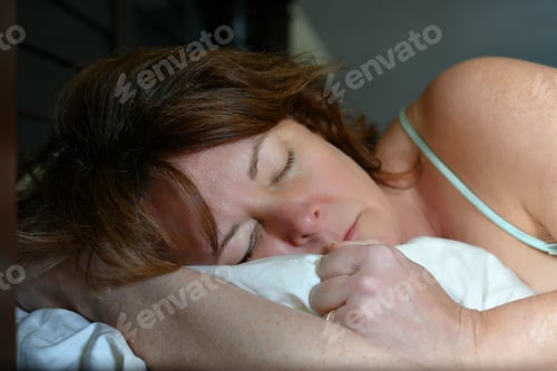 Preview: Middle-aged woman sleeping peacefully Gen-X no makeup
