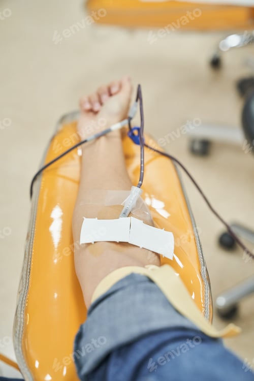Preview: Arm of female patient giving blood in hospital
