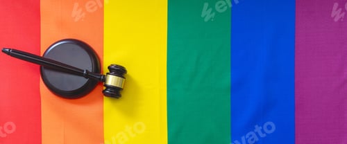 Preview: LGBT Law, Gay marriage. Judge gavel on rainbow color flag, overhead, banner. Transgender rights