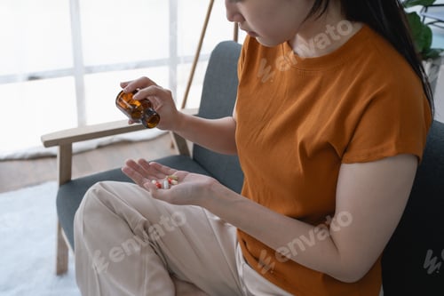 Preview: The woman, sitting on the sofa at home, stared at the medicine bottle, a symbol of her battle with d