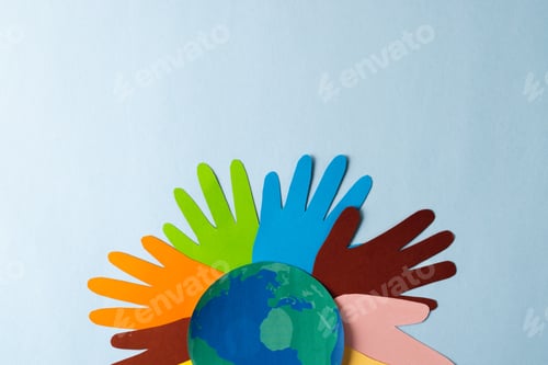Preview: Paper cut out of multi coloured hands and globe with copy space on blue background