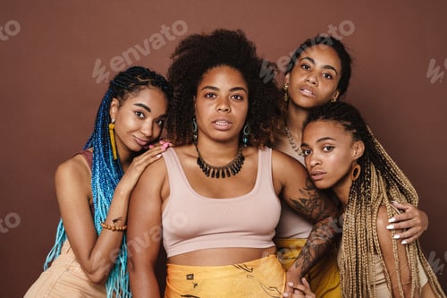 Preview: Young black four women hugging and posing at camera