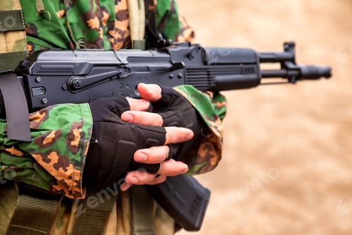 Preview: Close up ukrainian soldier man dressed military disguise camouflage uniform with weapon in woodland