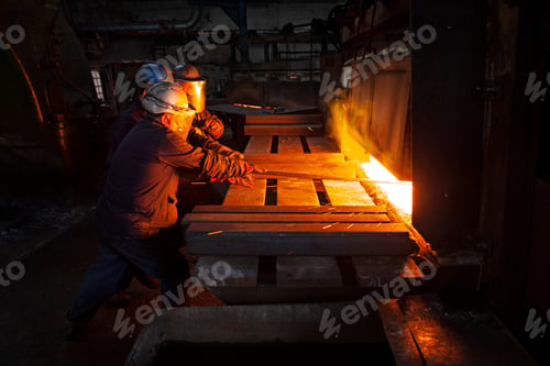 Preview: 100mm square steel billet is removed from furnace as cold steel billet waits in foreground to be