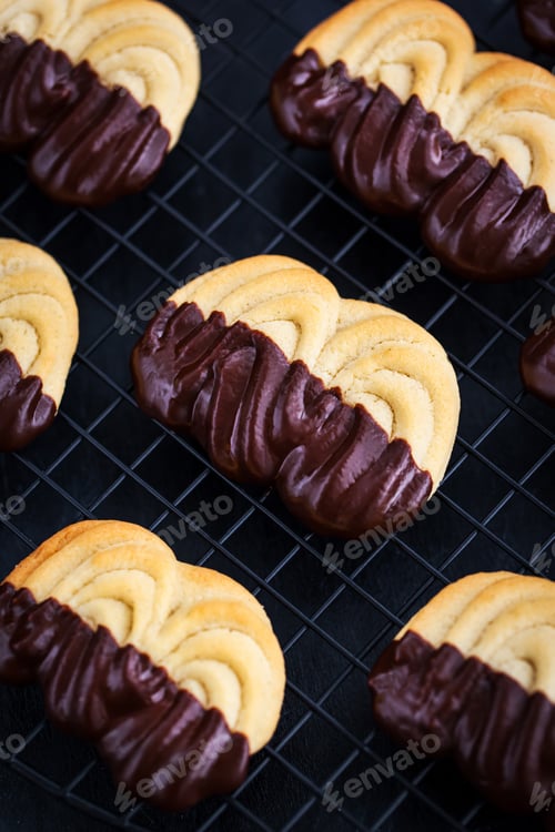 Preview: Homemade chocolate dipped shortbread cookies on dark background