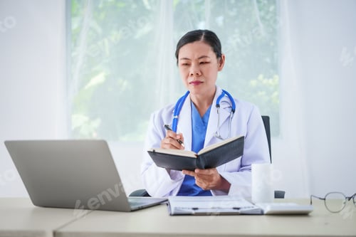 Preview: An Asian female doctor sits at her desk, conducting an online consultation. This faster, cheaper