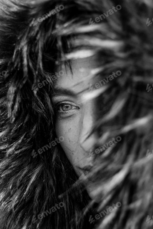 Preview: Close up on eyes of a pretty young woman in a big fur coat