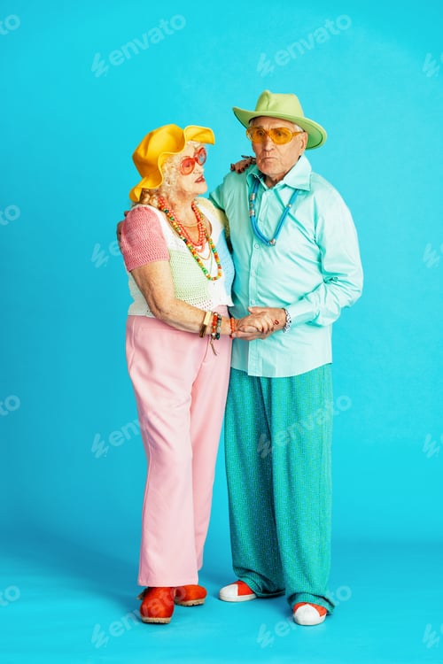 Preview: Beautiful senior old couple wearing fancy party clothes acting in studio on a colored background.