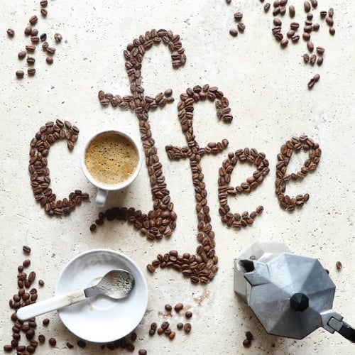 Preview: Overhead view of coffee with creative text made with coffee beans