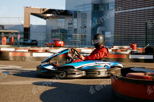 Preview: Diver racing on go-cart track outdoors enjoying competitive activity