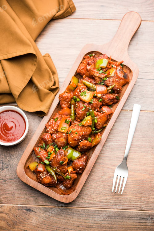 Preview: Delicious and Colorful Chicken Manchurian Dish on Wooden Tray