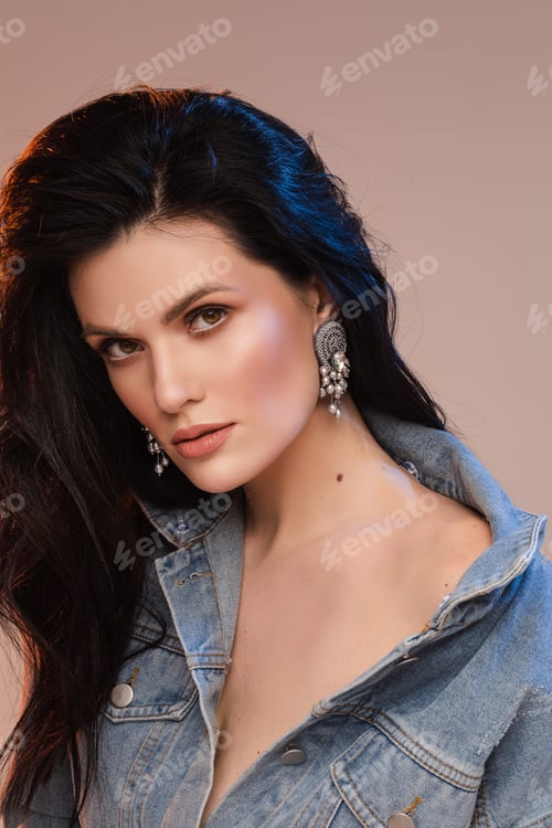 Preview: Stylish pretty lady with beautiful earrings in studio