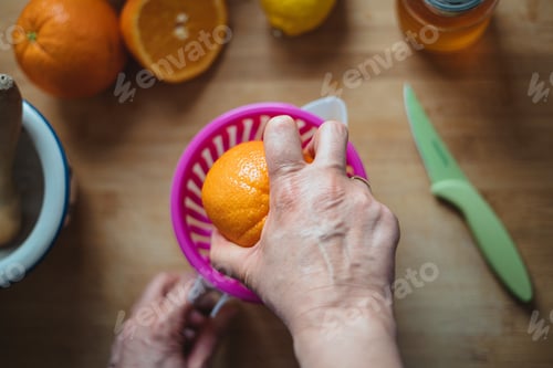 Preview: Woman squeezing orange.