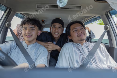 Preview: Happy Muslim Group Driving Car For Holiday With Exhausted Friend Sleeping In Background
