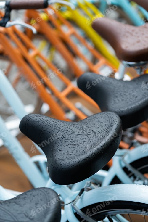 Preview: Bicycle saddle outside wet with rain, closeup. Selective focus.