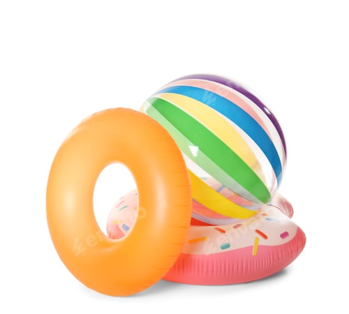 Preview: Bright inflatable rings and ball on white background. Summer holidays