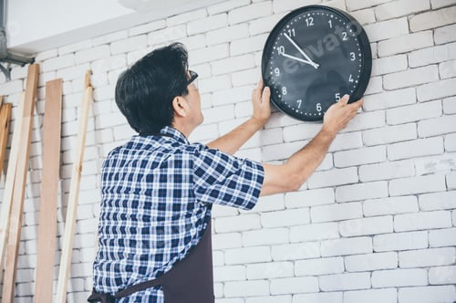 Preview: Grandfather repair and hanging clock on the wall at home, sets time clock