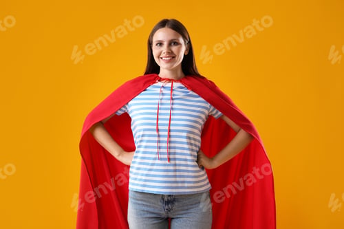 Preview: Woman wearing superhero cape on yellow background