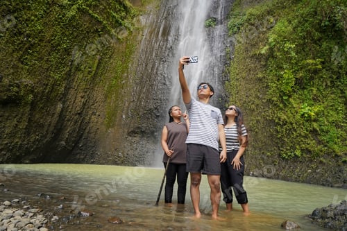 Preview: small group of young asian indonesian man and woman taking selfie photos