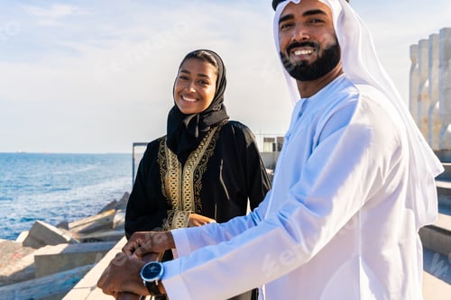 Preview: Traditional arab couple wearing emirati clothing dating outdoors