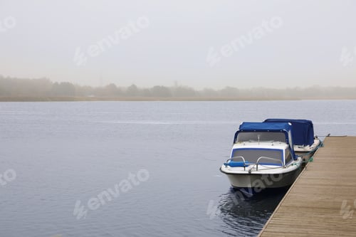Preview: Picturesque view of wooden pier with moored boat