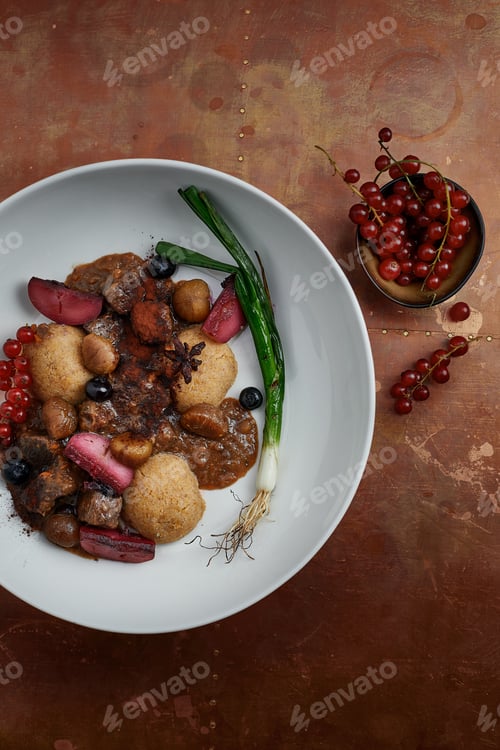 Preview: delicious Hummus dish with berries, veggies and sauce in restaurant background. Hummus dish for