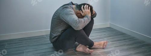 Preview: Unrecognizable man with problems sitting on the floor