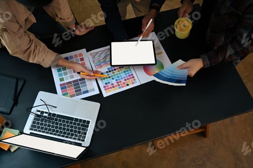 Preview: Overhead view team of graphic designer working with color chart and brainstorming for new project.