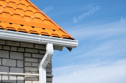 Preview: Rain Gutter Pipeline System on brick house , bright orange metal tile roof