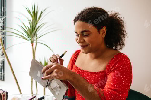 Preview: Transgender woman applying make up at home, creating online content