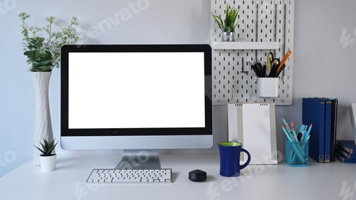 Preview: Front view of mock up computer with blank screen and office supplies on white table.