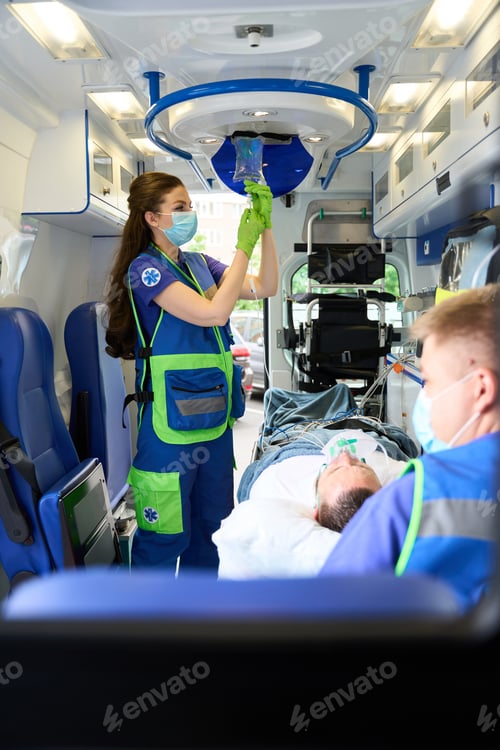 Preview: Female doctor puts an IV on patient in an ambulance