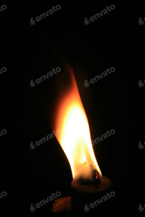 Preview: Vertical view of burning coal with silhouettes of a couple in the fire flame