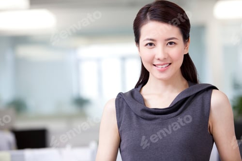 Preview: Portrait of smiling businesswoman in office