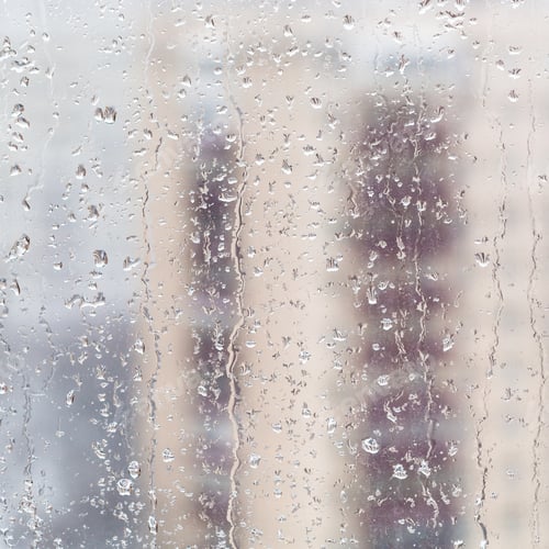 Preview: trickles of melting snow on home window in winter