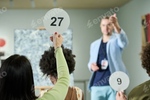 Preview: Young woman taking part in bidding