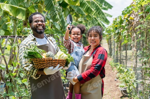 Preview: Farming family smiling at the camera while standing on the farm.