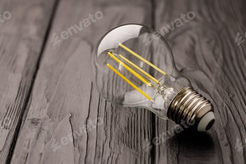 Preview: Light bulbs on dark wooden background close up
