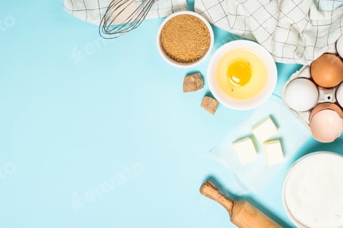 Preview: Baking ingredients at blue table top view.