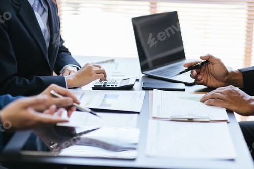 Preview: Close up view of business people discussing the charts and graphs showing the results of their succ