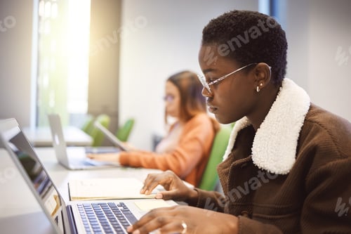 Preview: Education, black woman and laptop for studying, knowledge and learning in classroom. African Americ
