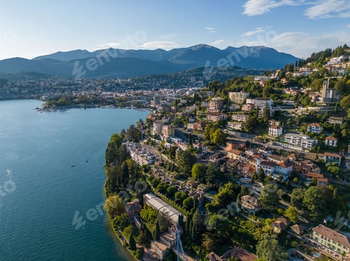 Preview: a large body of water near some houses and trees on top of mountains