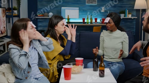 Preview: Group of multi-ethnic people having fun while playing board game