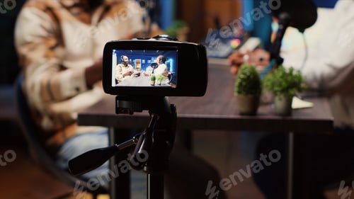 Preview: Camera Captures Podcast Session with Two Unidentified People