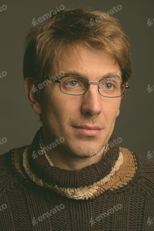 Preview: Handsome man wearing eyeglasses against gray background