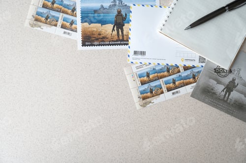 Preview: TERNOPIL, UKRAINE - June 28: Postage stamps "Russian warship... done". Laying down on the table